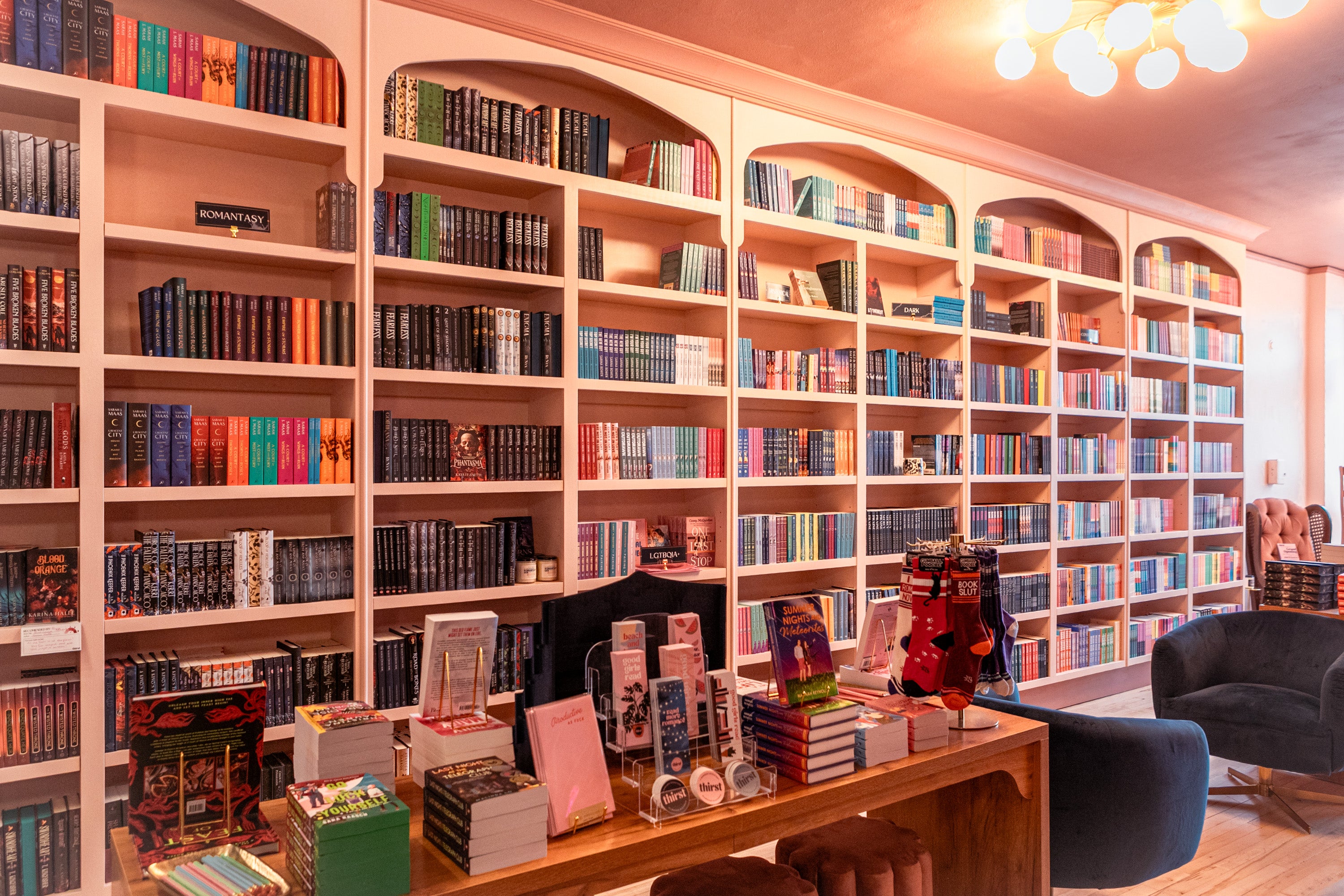 Library or bookstore with bookshelves filled with books and a desk.